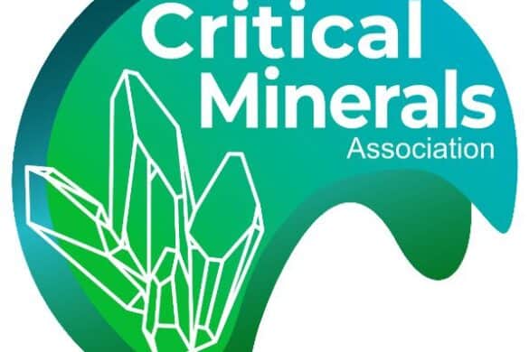 Critical Minerals Association logo featuring text in white and an outline of rock crystals in white on a green wave background