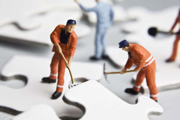 Worker figurines wih puzze. Image credit: David Crockett, Shuttlestock