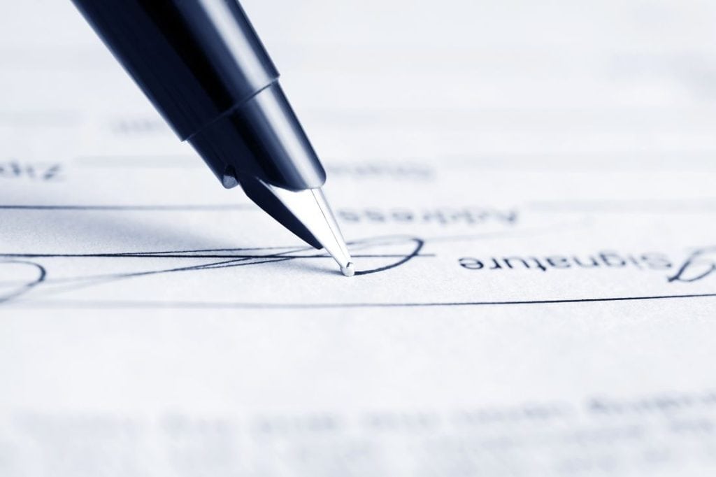 Black fountain pen signing a contract. Image by wrangler at Shutterstock.