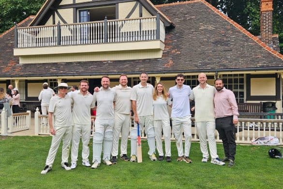 MMTA cricket team standing on the edge of a cricket field