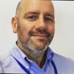 Simon Robinson of Advanced Alloy Services, a man with a trim beard, wearing a blue shirt