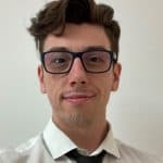 Theo Ruas, a young man with dark hair and square glasses